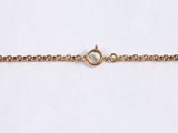a close up of a gold chain bracelet on a white background