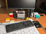 a desk with a keyboard, mouse and a monitor on it