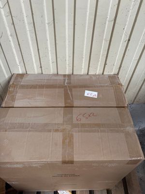 a cardboard box sitting on a pallet in front of a building