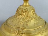 a gold plate with a bird on top of it