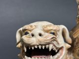 a figurine of a dog with a toothy grin