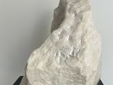 a large white rock on a black stand