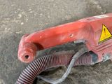 an image of a red corded drill on the ground