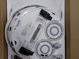 a cardboard box with a white electronic device inside of it