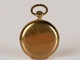 gold plated pocket watch on white background with reflection