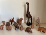 many wooden animals and a giraffe on the table