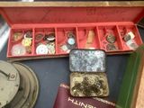 a red box with a bunch of jewelry inside of it