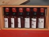 many bottles of wine sitting in a wooden box