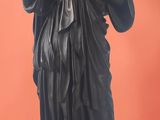 statue of a woman holding a bird in her hand on a black base