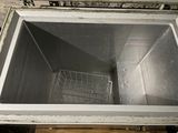 an image of a metal sink with a basket inside of it