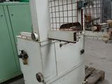 a white machine sitting on a pallet in a warehouse