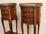 pair of antique french style bedside tables on a wooden stand