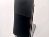 a cell phone that is sitting on top of a stand