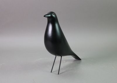 black bird on a white surface with a gray background