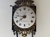 a clock that is hanging on the wall in the room