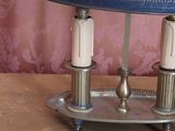 a lamp that is sitting on a table with a blue shade on it