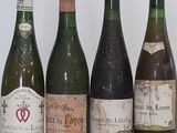 bottles of wine are lined up in a row on a table