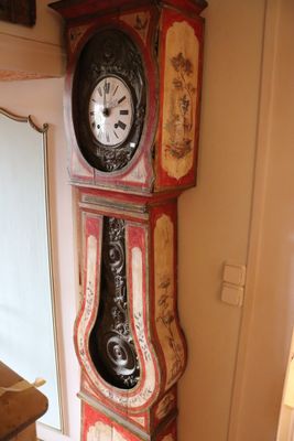 a grandfather clock in the corner of a living room