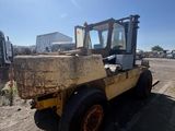 a tractor that is parked in the dirt