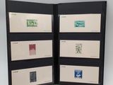 two open black folders with stamps on them on a white surface