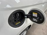 an electric car plugged in to a charging station on a city street