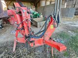 a red machine that is sitting in the grass