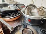 several pots and pans are on a stove top in a kitchen