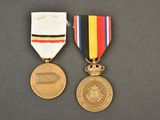 two medals on a table with a ribbon around them