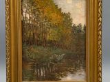 a painting of a river scene with trees and water in a gold frame