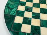 marble chess board with green and white squares on a white surface