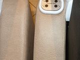 two leather seats with a phone in the middle of them
