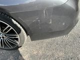 a close up of a car ' s front bumper with scratches on it