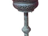a metal lamp that is on top of a stand