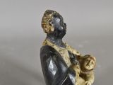 a figurine of a woman holding a baby