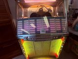 a juke box sitting on the floor in a living room