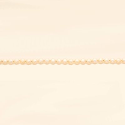 a close up of a pearl beaded necklace on a white background