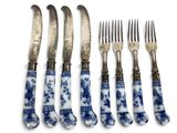 six pieces of blue and white chinaware with silverware on them