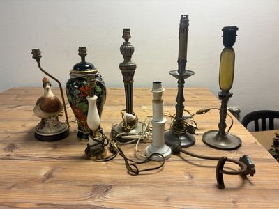 many different types of candles on a wooden table