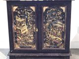 a black cabinet with a gold and black design on it