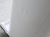 a large white object on a pallet in a warehouse