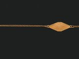 a gold bracelet with a diamond on it on a black background