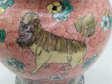 a pink vase with a picture of a lion on it
