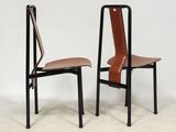 a pair of black and brown chairs with leather seats