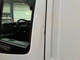 a white truck with the door open in a garage
