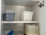 a cabinet with several containers and containers in it