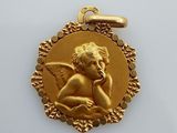 a close up of a gold medal with an angel on it