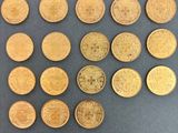 some gold coins are arranged in a square pattern on a gray surface