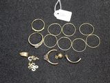 a lot of rings and earrings on a black surface