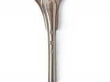 a silver spoon and a fork on a white surface