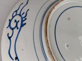 a blue and white plate with a design on it
